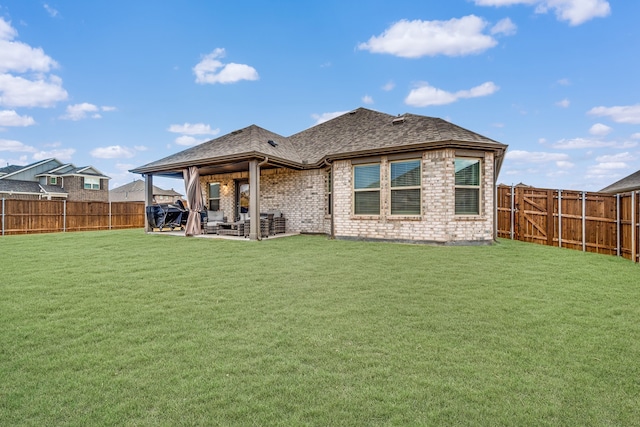 rear view of house with a patio area and a lawn