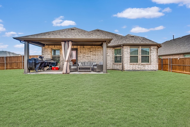 back of property featuring an outdoor hangout area, a patio area, and a lawn