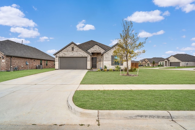 french provincial home with central air condition unit, a front lawn, and a garage