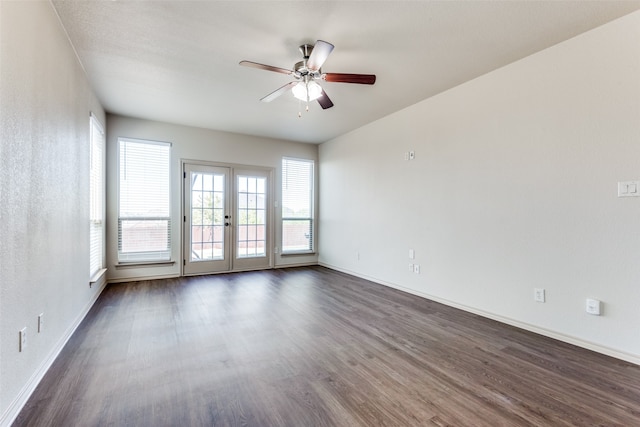 empty room featuring dark wood-type flooring, french doors, and ceiling fan