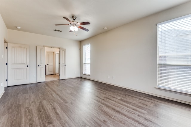 unfurnished bedroom with ceiling fan and light hardwood / wood-style floors