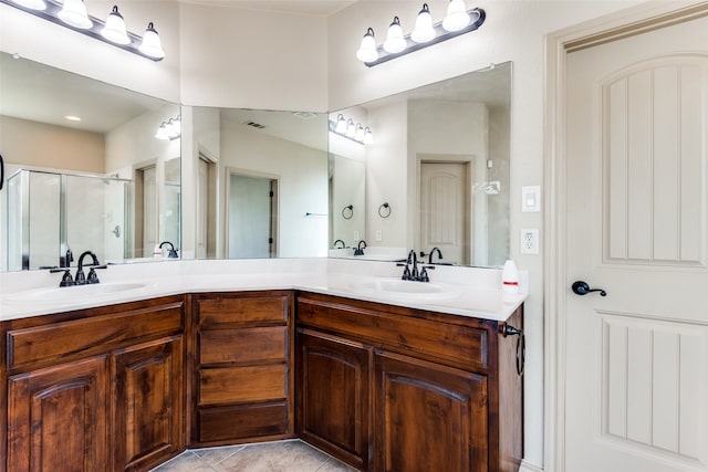 bathroom featuring vanity, walk in shower, and tile patterned flooring