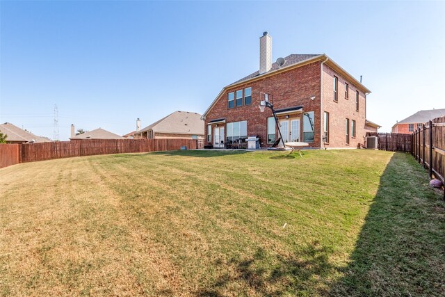 back of house with a yard, a patio, and central air condition unit