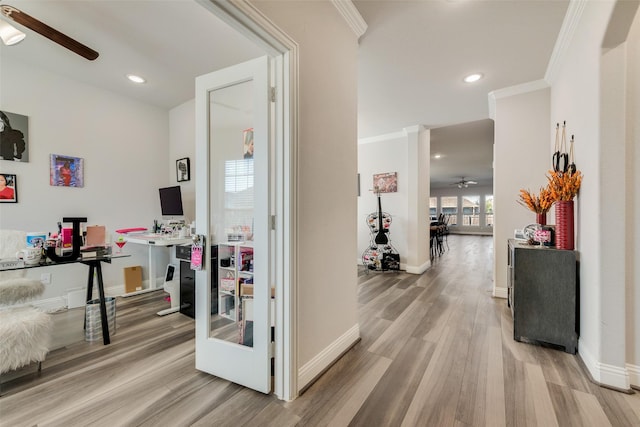 hall featuring ornamental molding and light hardwood / wood-style flooring