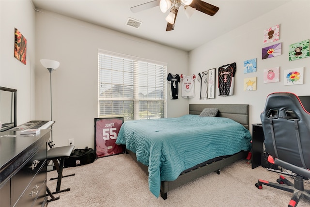 bedroom with ceiling fan and light colored carpet