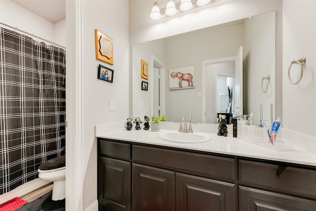 bathroom with vanity, a shower with shower curtain, and toilet