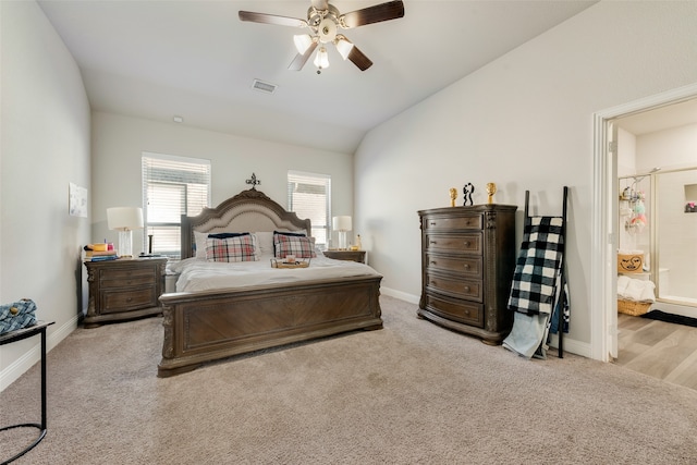 bedroom featuring ceiling fan, light colored carpet, and vaulted ceiling