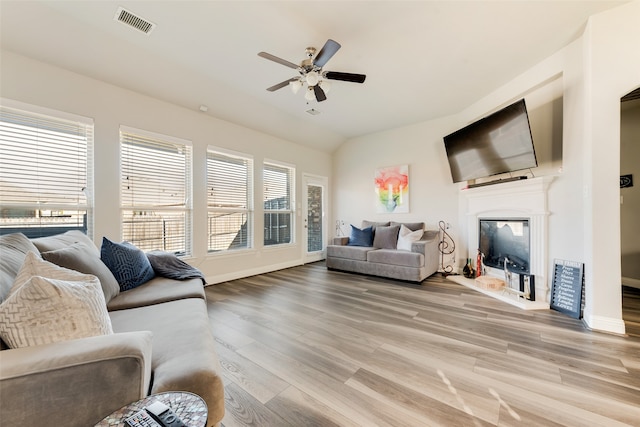 living room with a wealth of natural light, ceiling fan, and light hardwood / wood-style floors