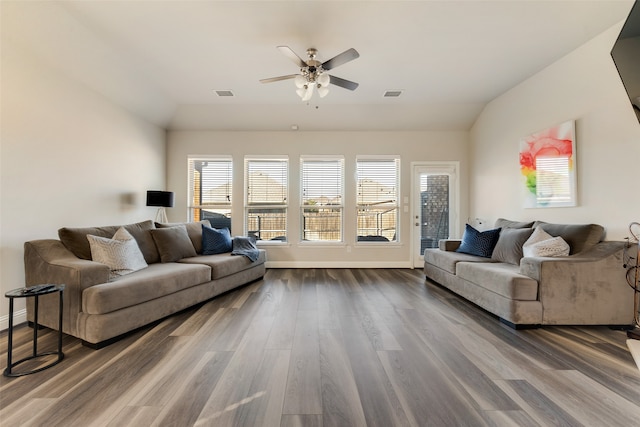 living room with ceiling fan, dark hardwood / wood-style flooring, and lofted ceiling