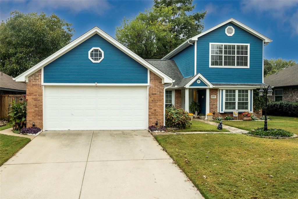 view of front facade featuring a garage and a front lawn