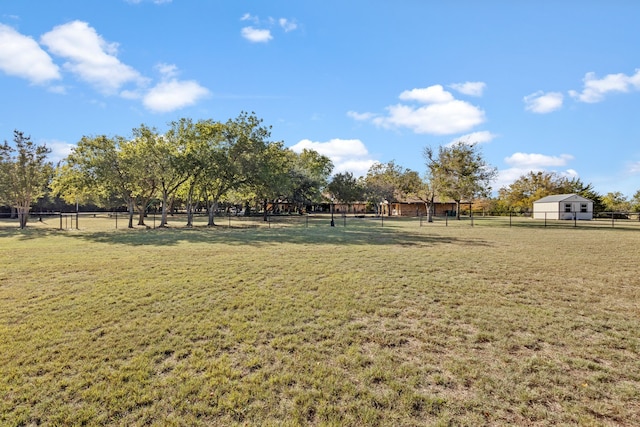 view of home's community with a yard and a rural view