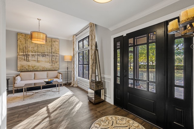 entrance foyer featuring ornamental molding and dark hardwood / wood-style floors