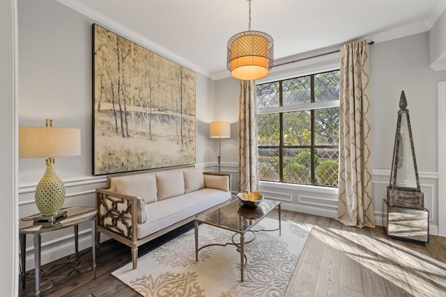 sitting room featuring ornamental molding and wood-type flooring