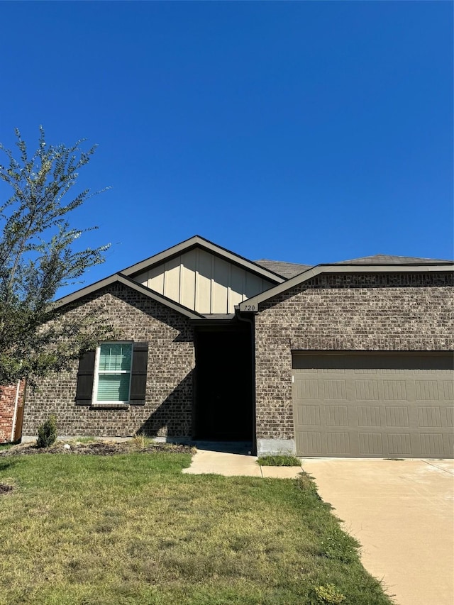 720 Juniper St, Anna, TX 75409 - ranch-style house with brick siding, board and batten siding, a front yard, a garage, and driveway