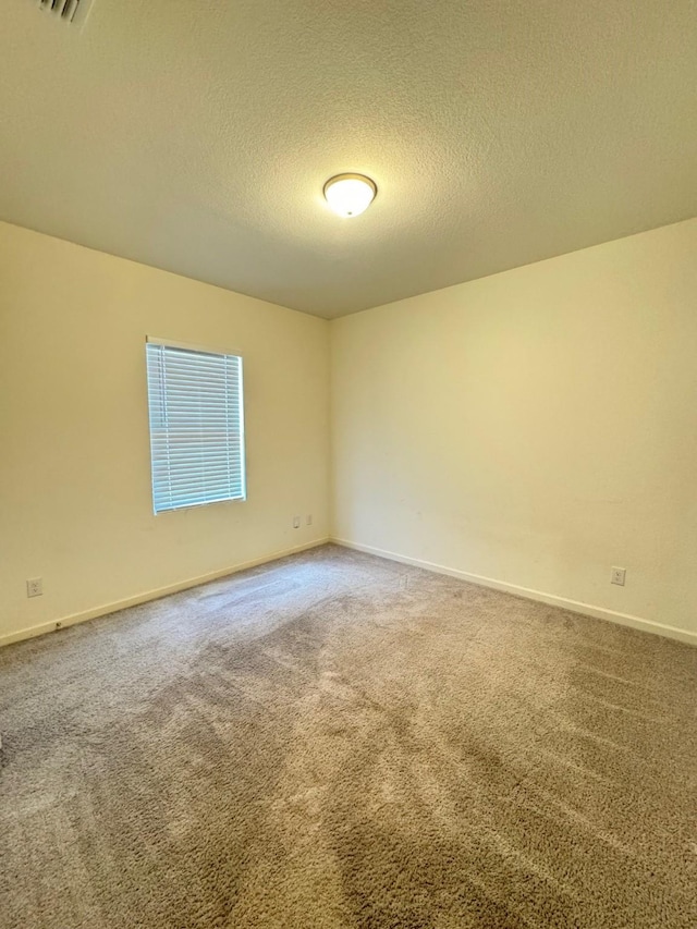 720 Juniper St, Anna, TX 75409 - unfurnished room featuring carpet floors, a textured ceiling, and baseboards