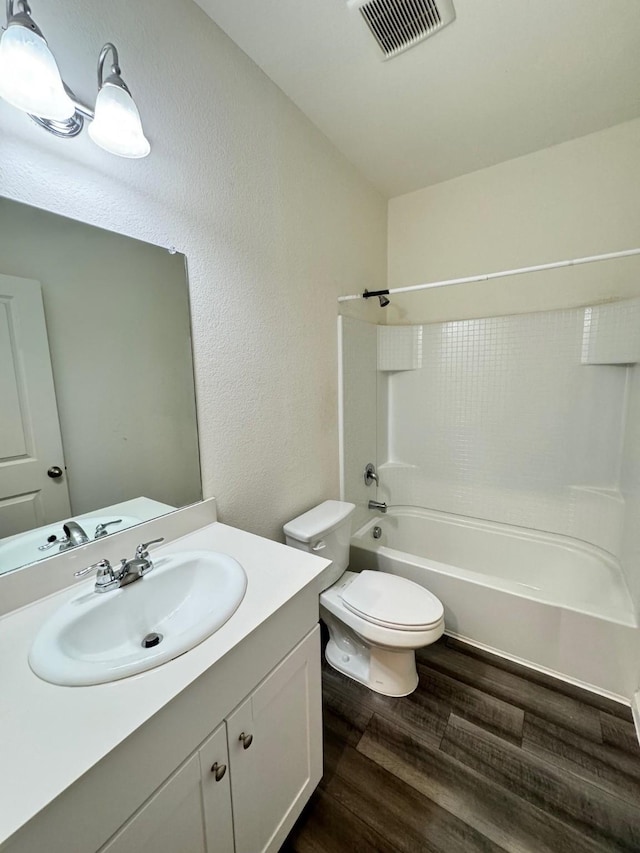720 Juniper St, Anna, TX 75409 - full bath with wood finished floors, toilet, shower / washtub combination, vanity, and a textured wall