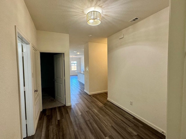 720 Juniper St, Anna, TX 75409 - hallway with dark wood-style flooring, a chandelier, baseboards, and a textured ceiling