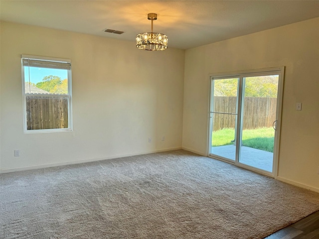720 Juniper St, Anna, TX 75409 - spare room with a chandelier, plenty of natural light, baseboards, and carpet
