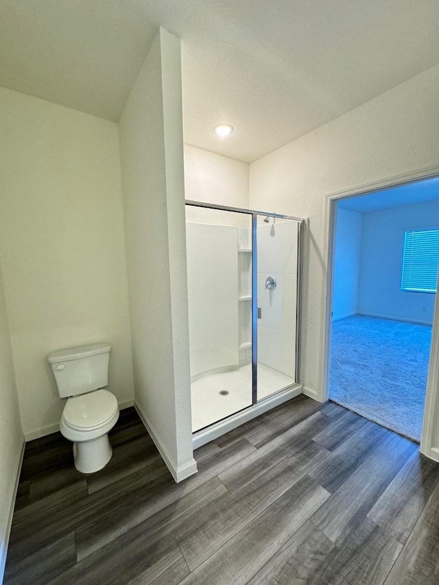 720 Juniper St, Anna, TX 75409 - bathroom featuring wood finished floors, a shower stall, toilet, and baseboards