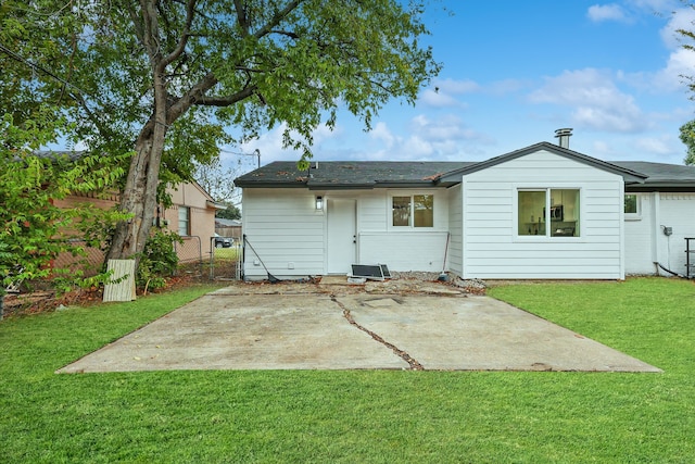 rear view of property featuring a patio area and a yard