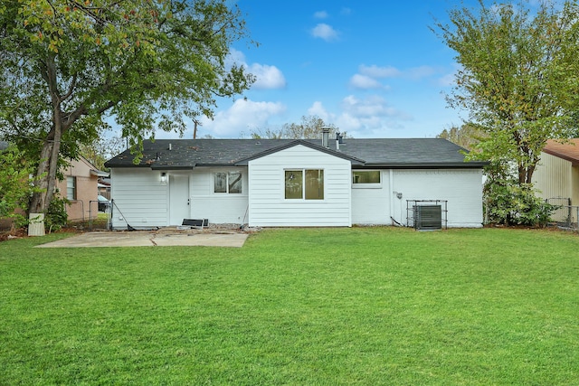 back of house featuring a lawn and a patio