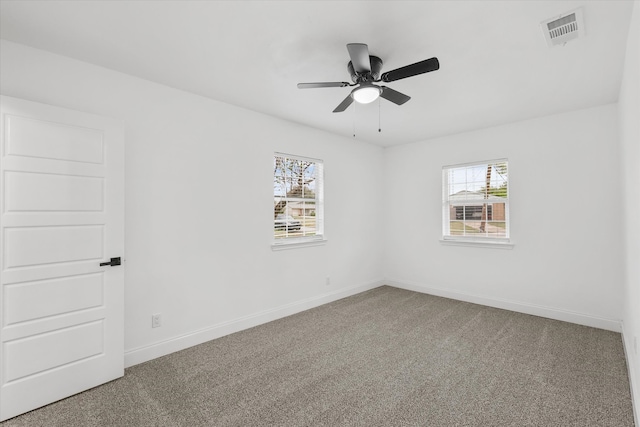 carpeted spare room featuring ceiling fan