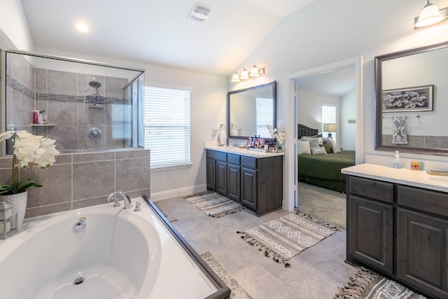 bathroom featuring vanity, lofted ceiling, separate shower and tub, and tile patterned flooring