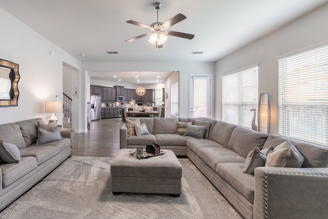 living room with ceiling fan and dark hardwood / wood-style floors