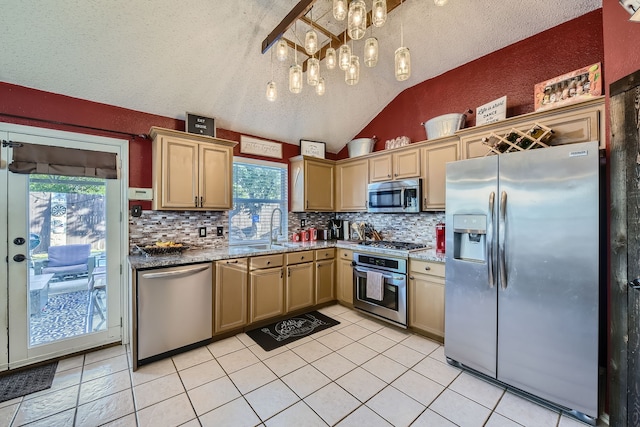 kitchen featuring appliances with stainless steel finishes, a textured ceiling, sink, and plenty of natural light