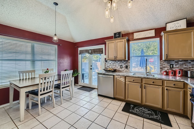 kitchen with a textured ceiling, stainless steel dishwasher, and plenty of natural light