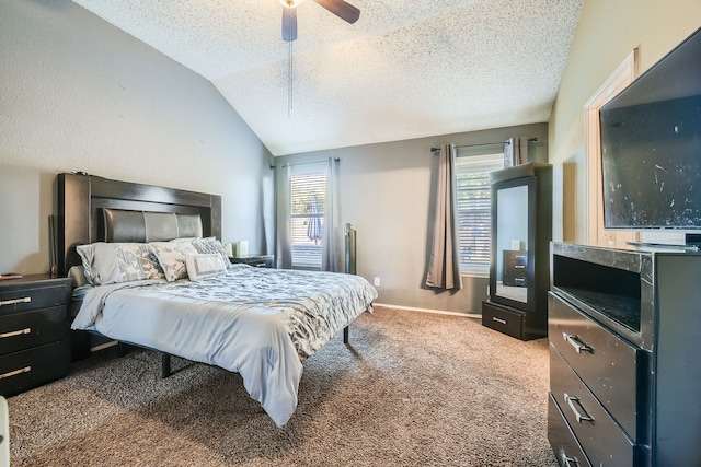 carpeted bedroom with lofted ceiling, a textured ceiling, and ceiling fan