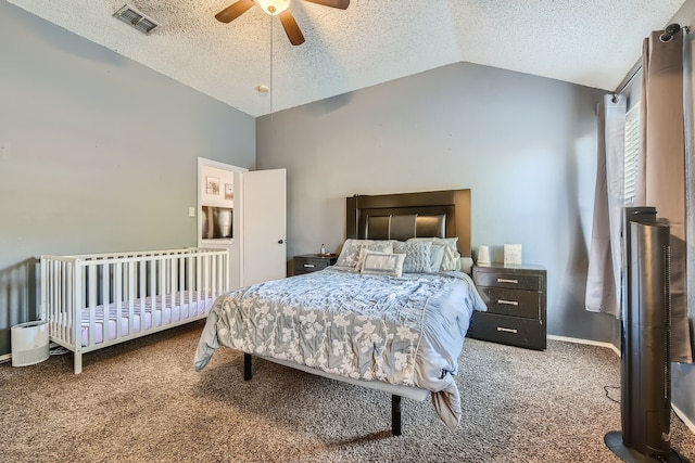 bedroom featuring lofted ceiling, a textured ceiling, carpet flooring, and ceiling fan