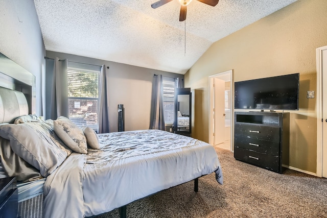 carpeted bedroom featuring ceiling fan, a textured ceiling, lofted ceiling, and ensuite bath