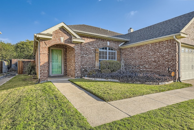 view of front of house featuring a front yard and a garage