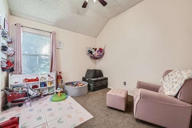 game room featuring lofted ceiling, a textured ceiling, carpet flooring, and ceiling fan