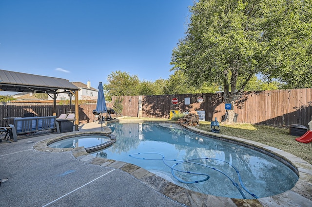 view of swimming pool with a patio, a gazebo, and an in ground hot tub