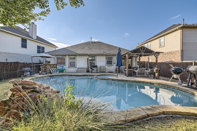 view of pool featuring area for grilling and a patio area