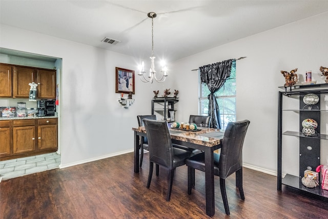 dining area featuring a chandelier and dark hardwood / wood-style flooring