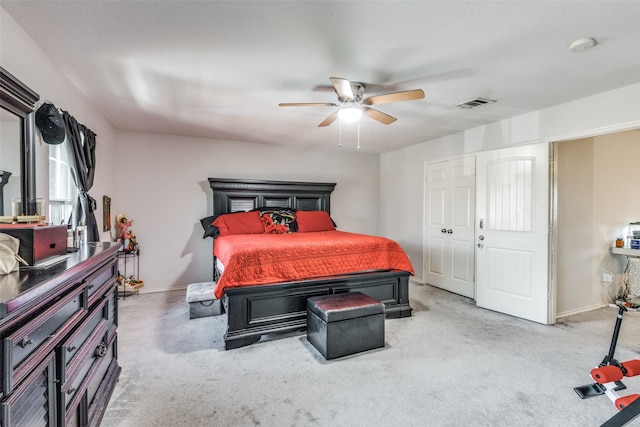 bedroom featuring light colored carpet, a closet, and ceiling fan