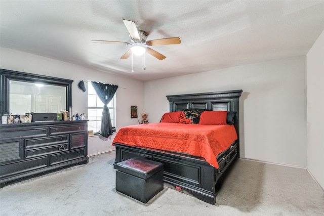 carpeted bedroom with a textured ceiling and ceiling fan