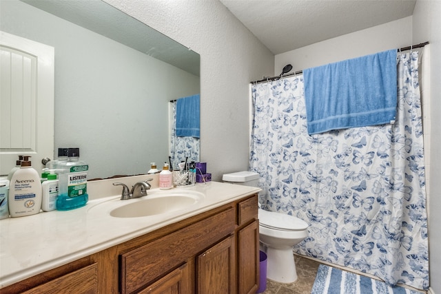 bathroom with tile patterned floors, toilet, a shower with curtain, vanity, and a textured ceiling