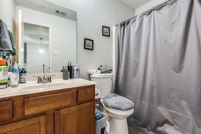 bathroom with vanity, toilet, and curtained shower