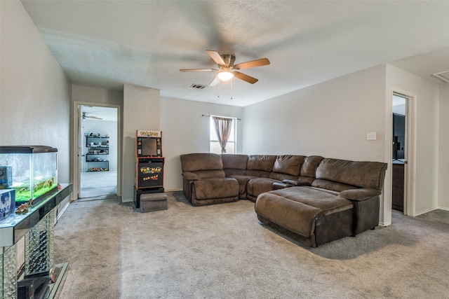 carpeted living room featuring ceiling fan