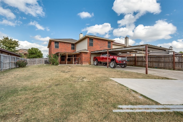 rear view of property featuring a carport and a lawn