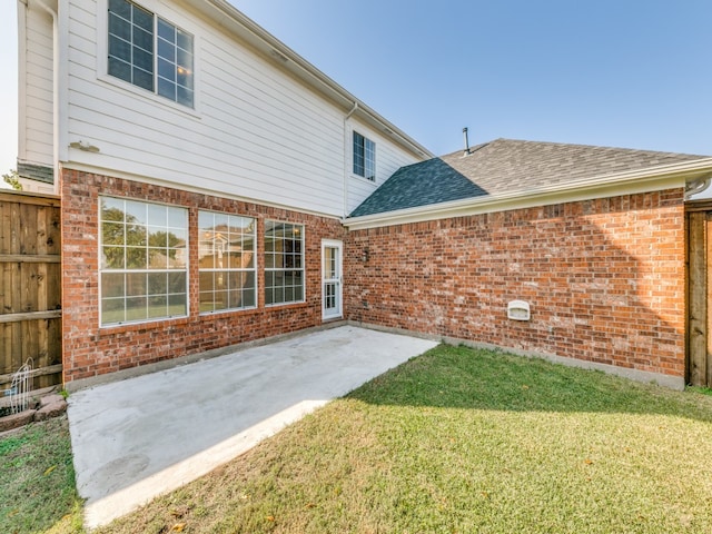 back of house featuring a yard and a patio