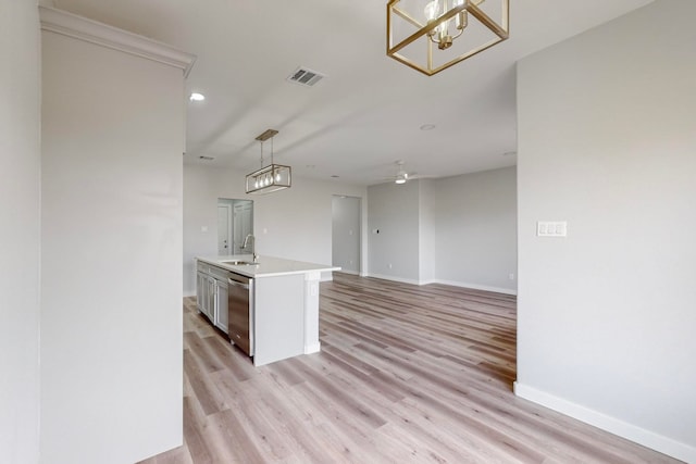 kitchen with dishwasher, a kitchen island with sink, sink, decorative light fixtures, and light wood-type flooring