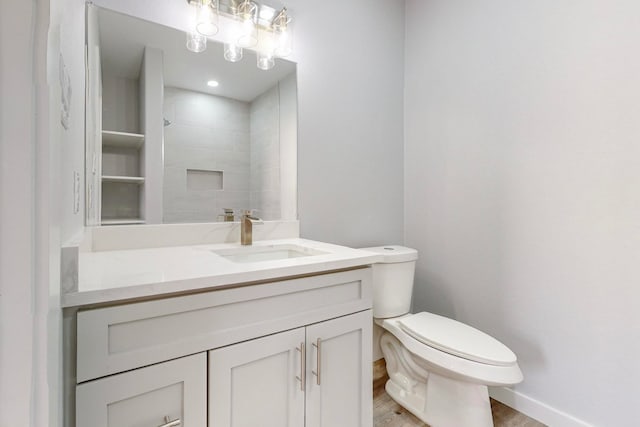 bathroom featuring vanity, toilet, and hardwood / wood-style flooring