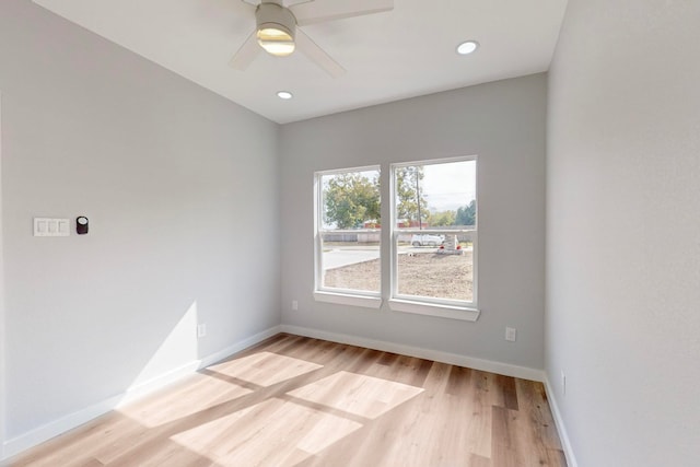 spare room with light hardwood / wood-style flooring and ceiling fan