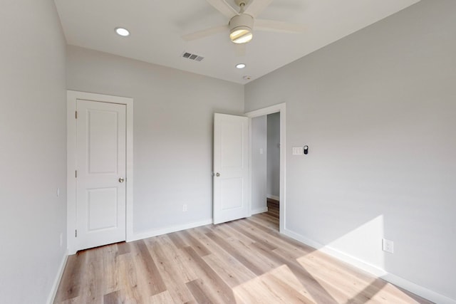 unfurnished bedroom with ceiling fan and light wood-type flooring