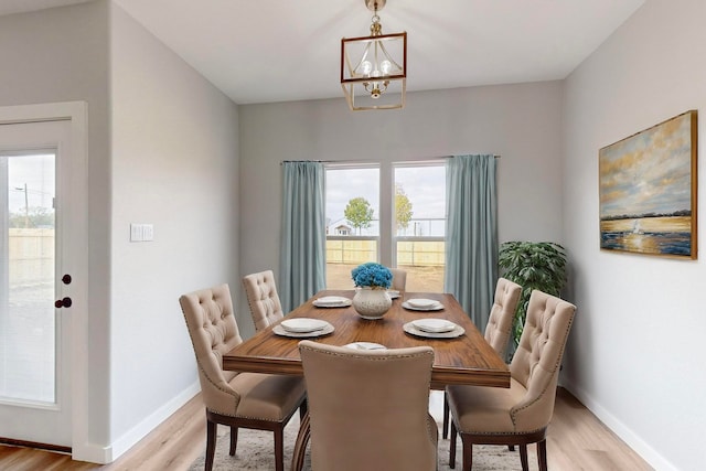 dining room featuring light hardwood / wood-style floors and a notable chandelier